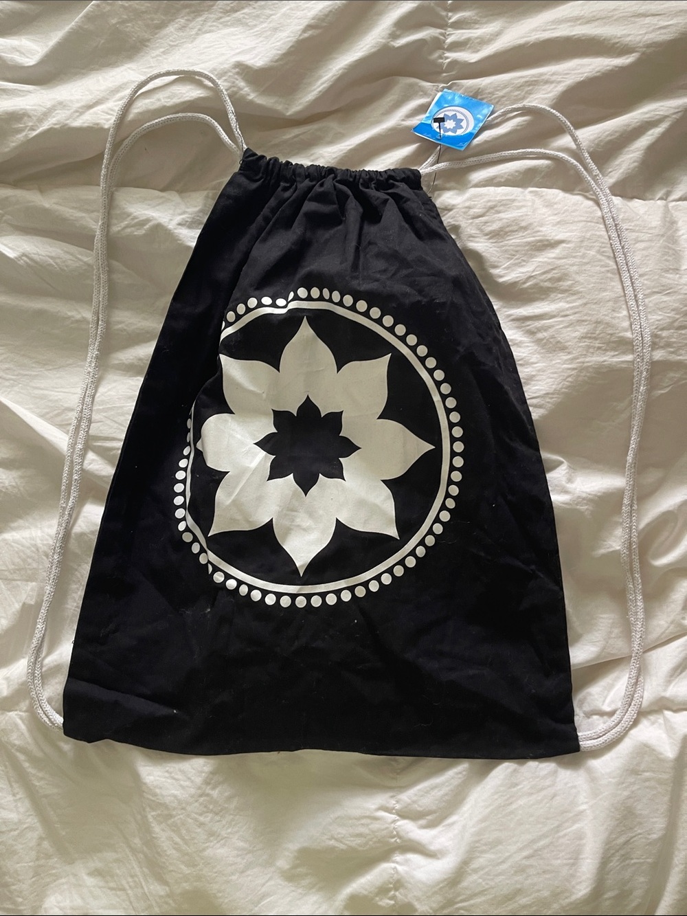 Black Drawstring Backpack with White Floral Medallion